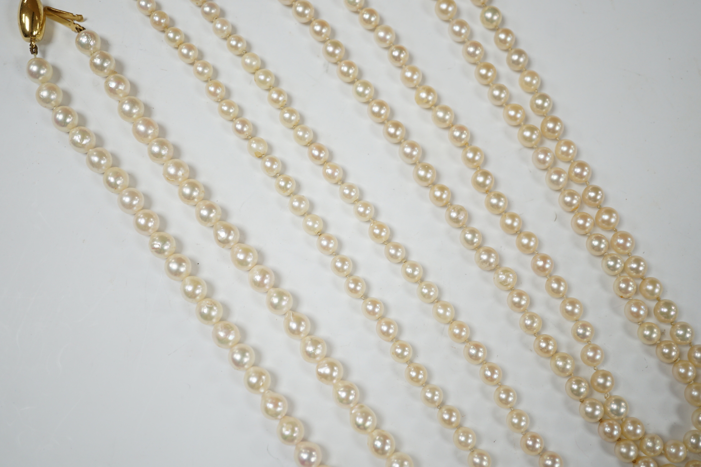 Three assorted modern single strand cultured pearl necklaces, one with 585 clasp, longest 76cm.